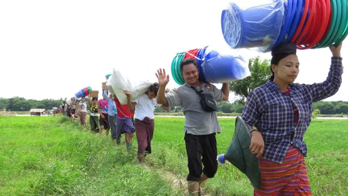 people carrying buckets