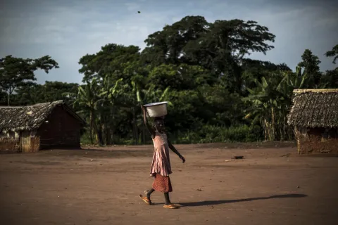 Woman carrying a bowl on her head