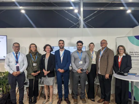 A group of people stand together after the panel event at COP29