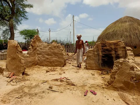A man stands among the ruins of a house destroyed by the cyclone.