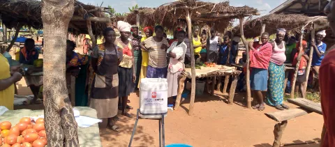 People gather at a hand Washing facility at Awch market.