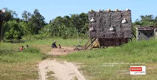 Houses with sandbags on their roofs to help withstand winds