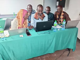 People in front of a computer learning