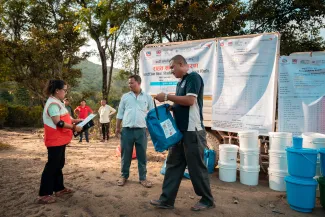 humanitarian workers organise a distribution of goods in Nepal