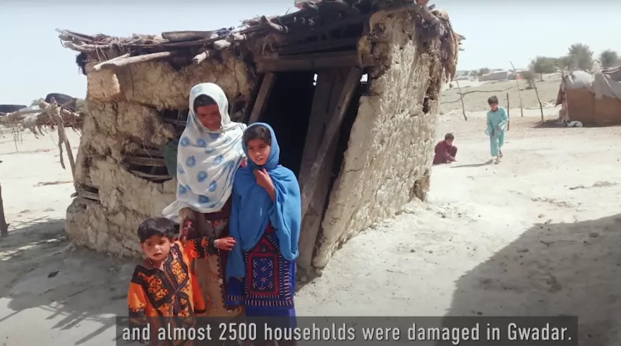 Family in front of a collapsed house