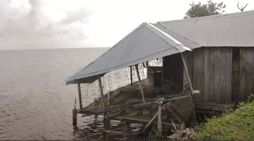 A collapsed building by the water