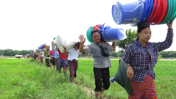 people carrying buckets